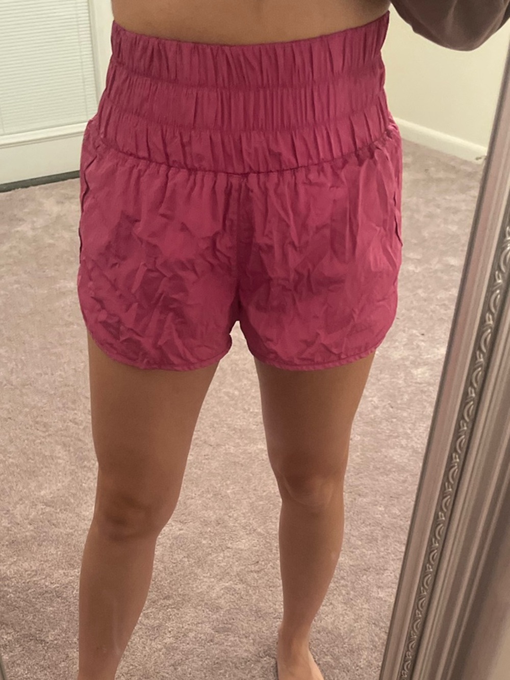 FP Movement pink high-waisted shorts.